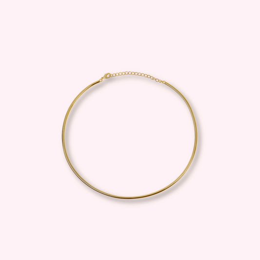 Hard gold choker — polished gold-tone rigid collar necklace, minimal and stackable.