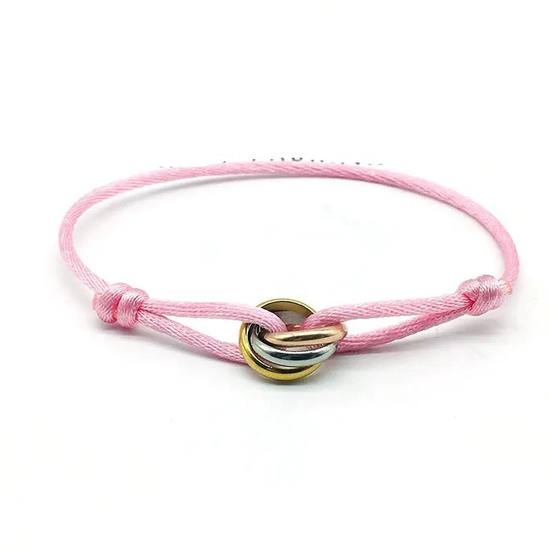 Gold tennis bracelet with a full circle of horizontally set oval purple amethyst or cubic zirconia stones.