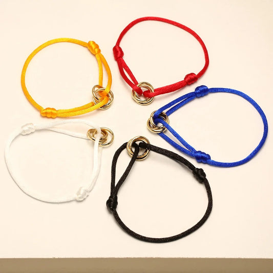 Adjustable cord bracelets with double gold rings in yellow, red, blue, white and black — MARO Jewelry.